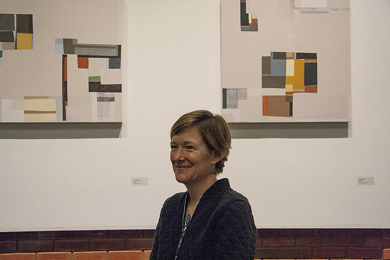 Karen Dow in front of her paintings