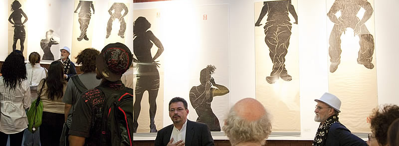 Antonio Martorell discusses his recent installation, GESTUARIO with NCC students. Benjamin Ortiz, guest curator, left, and Antonio Martorell at the opening of GESTUARIO at the NCC Art Gallery.